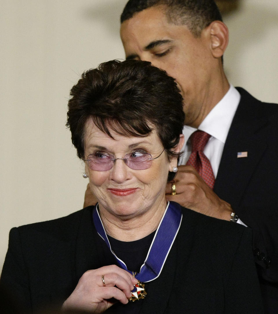 FILE - In this Aug. 12, 2009 file photo, President Barack Obama presents the 2009 Presidential Medal of Freedom to Billie Jean King, known for winning the famous "Battle of the Sexes" tennis match, and championing gender equality issues, during ceremonies at the White House in Washington. Japanese Prime Minister Shinzo Abe and his Chinese counterpart Xi Jinping appear not to be bothered by the international ruckus over Russia's law restricting gay rights. Unlike President Barack Obama, who pointedly declined to attend the Winter Olympics, the leaders of the world's second and third largest economies — where gay rights are not a hot-button political issue — are going to Sochi. King, who was selected to help lead the U.S. delegation to the Games, has been outspoken in her opposition to Russia's anti-gay law. (AP Photo/J. Scott Applewhite, File)