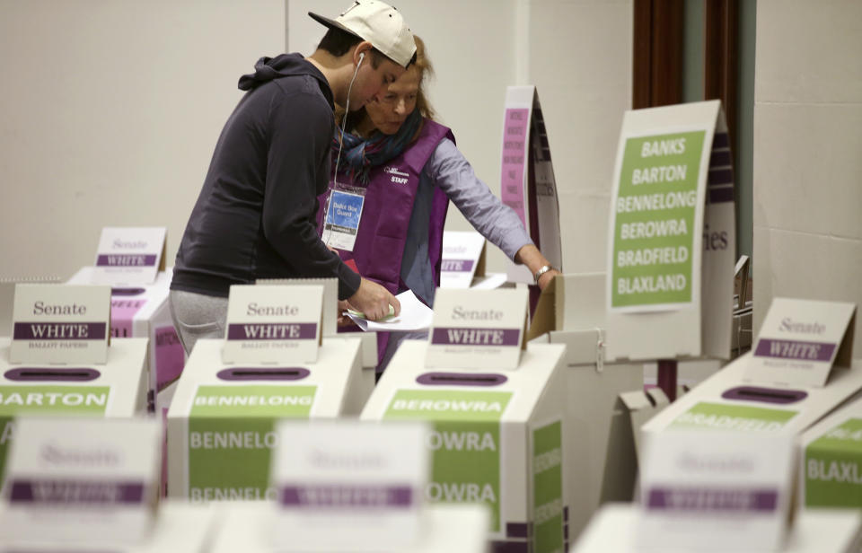 A voter casts their ballot at Town Hall in Sydney, Australia, in a federal election, Saturday, May 18, 2019. Polling stations have opened in eastern Australia on Saturday in elections that are likely to deliver the nation's sixth prime minister in as many years. (AP Photo/Rick Rycroft)
