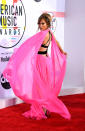 <p>Jennifer Lopez made sure to steal the limelight in a neon pink Georges Chakra dress at the music awards. Not only did the gown feature a plunging v-neck and thigh-high split skirt but an unusual criss-cross back (and cape for good measure). <em>[Photo: Getty]</em> </p>