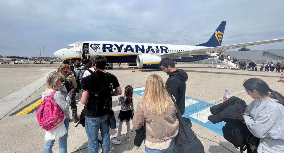 Passengers boarding Ryan Air plane in Europe.