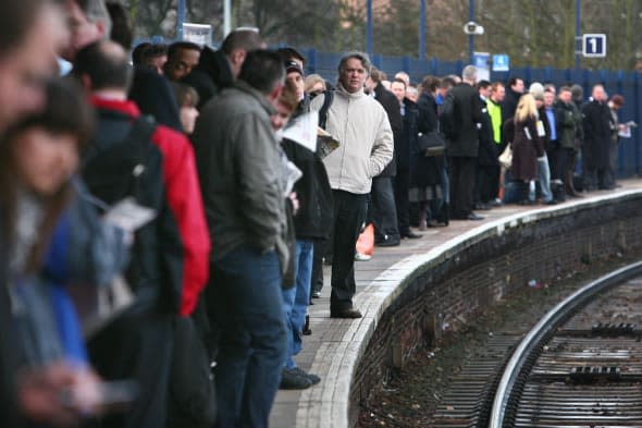 File photo dated 05/03/09 of commuters waiting on the a platform as people are travelling further to get to work but the number of commuters is falling as more staff work from home, according to official figures. PRESS ASSOCIATION Photo. Issue date: Wednesday March 26, 2014. Based on Census statistics, the average distance travelled to work in England and Wales increased from 8.3 miles (13.4km) in 2001 to 9.32 miles (15km) in 2011. Those living in the Midlands and south west England had the largest increase in average distance travelled between 2001 and 2011 - going an extra 1.36 miles (2.2km). See PA story TRANSPORT Commute. Photo credit should read: Gareth Fuller/PA Wire