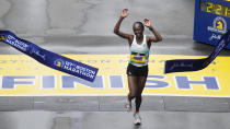 Hellen Obiri, of Kenya, breaks the tape at the finish line to win the women's division of the Boston Marathon, Monday, April 17, 2023, in Boston. (AP Photo/Charles Krupa)