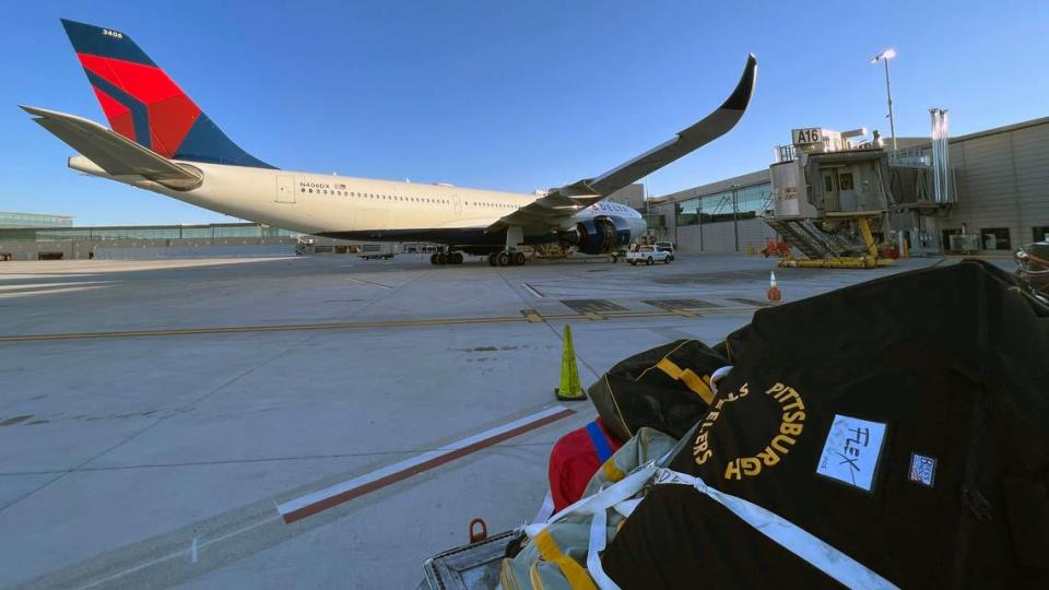 Luggage waits to be transferred to another airplane after the Pittsburgh Steeler’s chartered flight was diverted and made an emergency landing at Kansas City International Airport early Monday. The Delta Airlines aircraft experienced a problem while headed from Las Vegas to Pittsburgh following the Steelers’ win on Sunday Night Football.