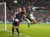 Celtic's Charlie Mulgrew (R) challenges Ajax's Kolbeinn Sigthorsson during their Champions League soccer match at Celtic Park Stadium, Scotland October 22, 2013. REUTERS/Russell Cheyne (BRITAIN - Tags: SPORT SOCCER)