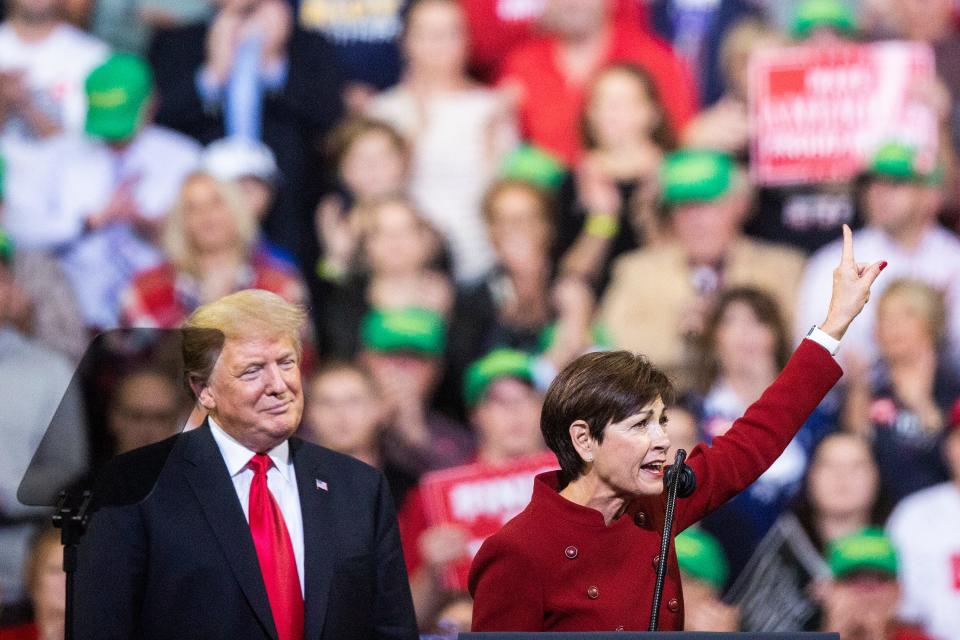 Iowa Governor Kim Reynolds joins President Donald Trump on stage during a rally at the Mid-America Center on Tuesday, Oct. 9, 2018, in Council Bluffs. 