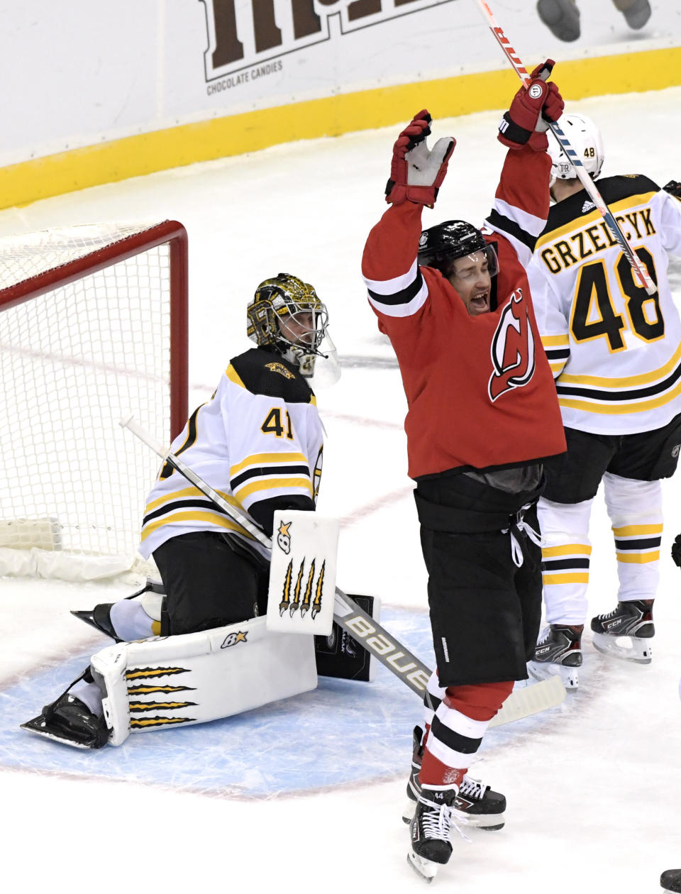 New Jersey Devils left wing Miles Wood (44) celebrates his goal as Boston Bruins goaltender Jaroslav Halak (41) reacts during the first period of an NHL hockey game Saturday, Jan. 16, 2021, in Newark, N.J. (AP Photo/Bill Kostroun)