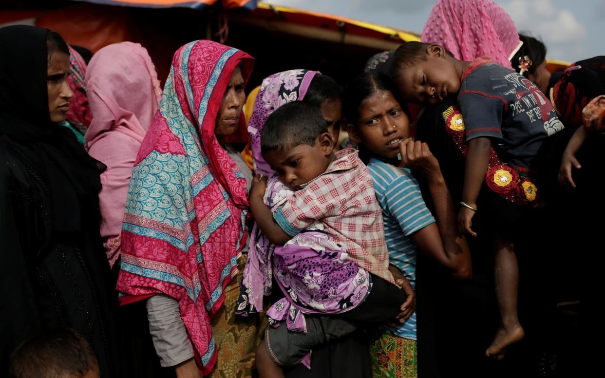 Rohingya refugees line up for a food supply distribution at the Kutupalong refugee camp near Cox's Bazar - REUTERS
