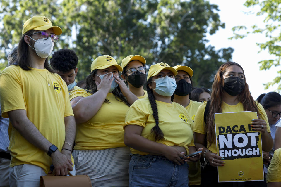 Activists listen during a news conference to mark the 10th anniversary of the 