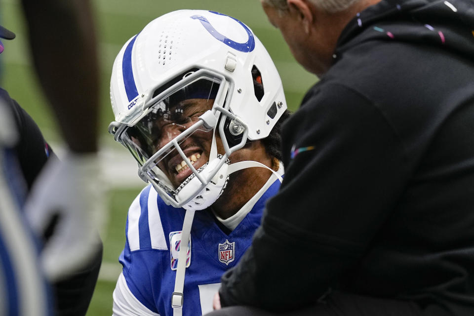 Indianapolis Colts quarterback Anthony Richardson winces in pain after being injured during the first half of an NFL football game against the Tennessee Titans, Sunday, Oct. 8, 2023, in Indianapolis. (AP Photo/Darron Cummings)