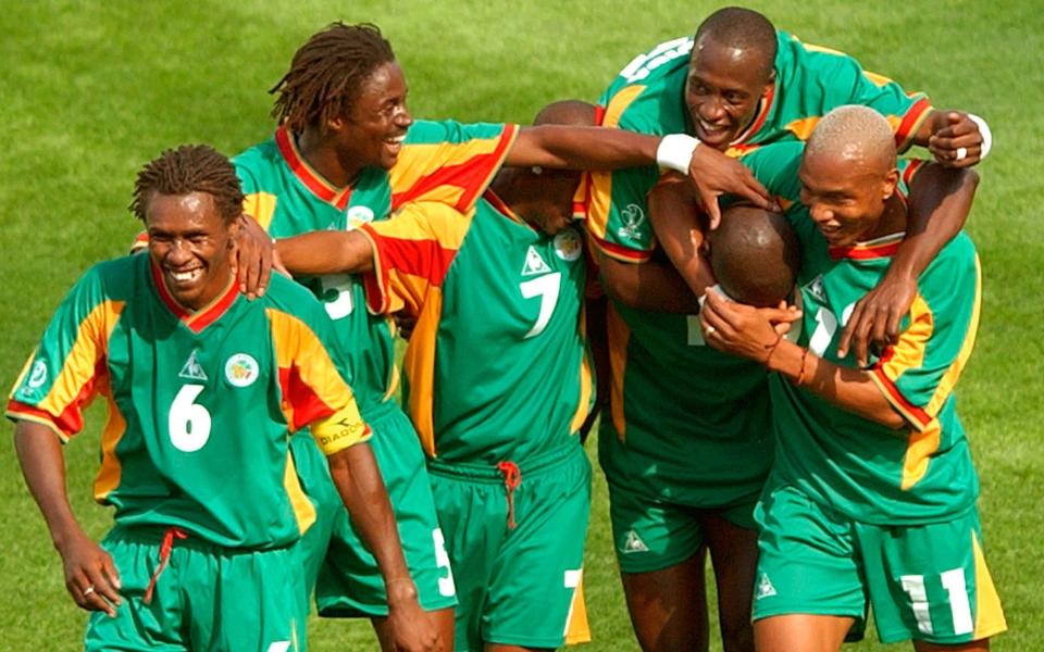 In this June 11, 2002 file photo Senegal's players celebrate after scoring their third goal in the first half of their 2002 World Cup Group A soccer match against Uruguay at the Suwon World Cup stadium in Suwon, South Korea. From left are Aliou Cisse, Alassane Ndour, Henri Camara, Khalilou Fadiga, Papa Bouba Diop (hidden) and El Hadji Diouf - The maritime tragedy that shaped Aliou Cisse's career- by the men who managed him - Lawerence Jackson/AP