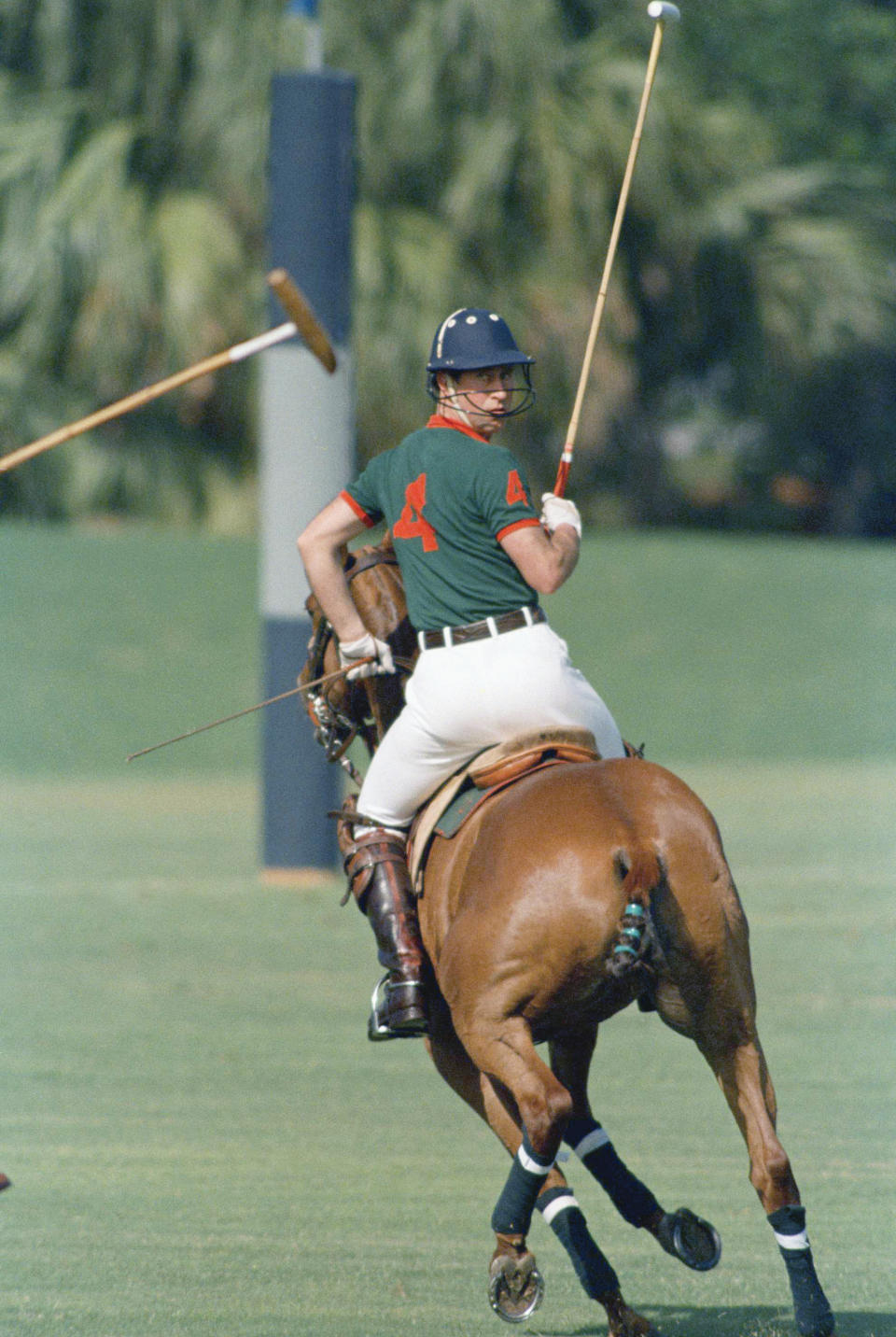 FILE - In this Feb. 18, 1989 file photo Prince Charles looks over his shoulder as he plays in the first Prince of Wales Cup polo match at the Windsor Polo and Beach Club in Vero Beach, Fla. USA. Charles’ wife, Camilla, the duchess of Cornwall wrote in a tribute ahead of Charles' birthday on Wednesday Nov. 14, 2018, in The Telegraph Magazine “I don’t think he thinks he’s 70,” she wrote “I think it’s just a number to him. There’s no way that he will slow down. You must be joking. I keep saying 70 is getting on a bit. It’s not very old but it is old. You have to slow down a bit.” (AP Photo/Kathy Willens, File)