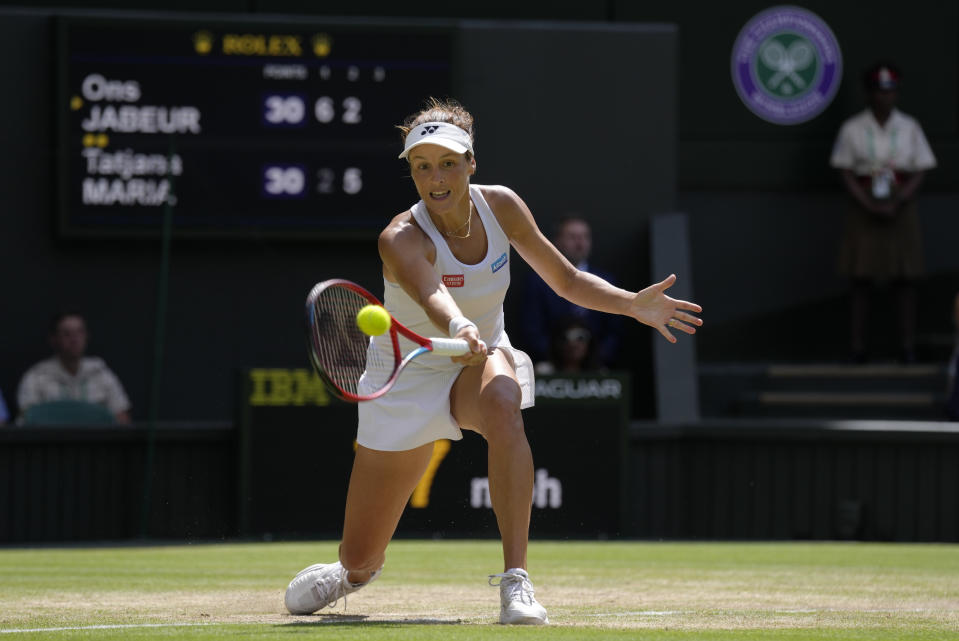 Germany's Tatjana Maria returns to Tunisia's Ons Jabeur in a women's singles semifinal match on day eleven of the Wimbledon tennis championships in London, Thursday, July 7, 2022. (AP Photo/Kirsty Wigglesworth)