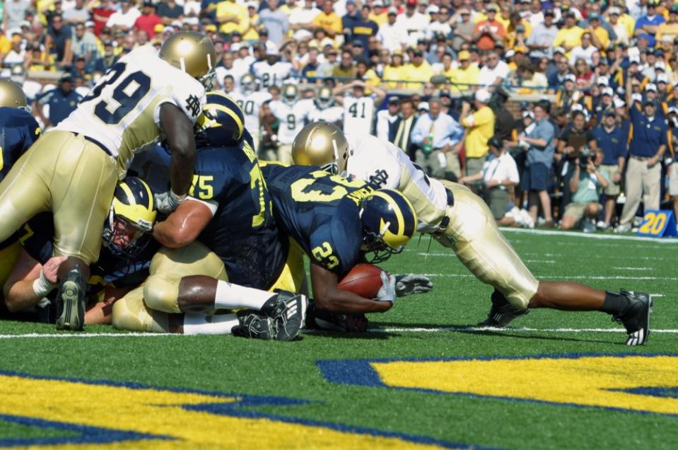 ANN ARBOR, MI – SEPTEMBER 13: Running back Chris Perry #23 of the University of Michigan Wolverines dives across the goal line for a touchdown against the Notre Dame University Fighting Irish at Michigan Stadium on September 13, 2003 in Ann Arbor, Michigan. Michigan defeated Notre Dame 38-0. (Photo by Tom Pidgeon/Getty Images)
