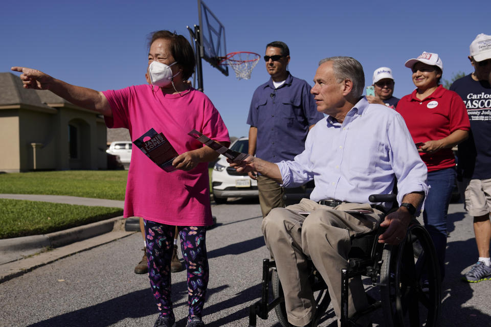 Texas Gov. Greg Abbott, right, canvasses for votes, Saturday, Oct. 1, 2022, in Harlingen, Texas. As Democrats embark on another October blitz in pursuit of flipping America's biggest red state, Republicans are taking a swing of their own: Making a play for the mostly Hispanic southern border on Nov. 8 after years of writing off the region that is overwhelmingly controlled by Democrats. (AP Photo/Eric Gay)