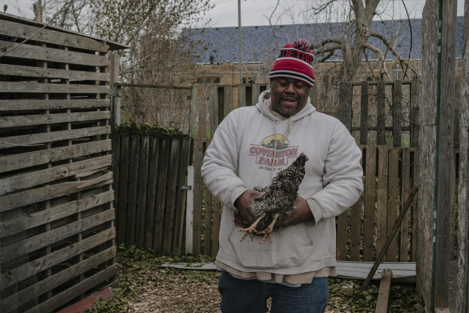 Mark Covington catches a chicken at the Georgia Street Community Collective on Nov. 12. In 2008, Covington started tending three vacant lots, turning them into a community garden to prevent illegal dumping. (Photo: Sean Proctor for HuffPost)