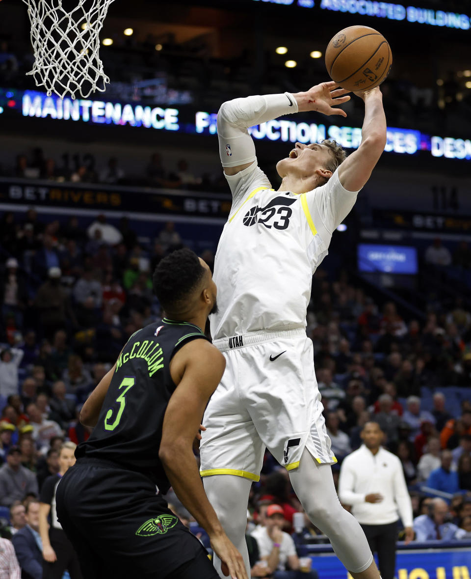 New Orleans Pelicans guard CJ McCollum (3) blocks the shot of Utah Jazz forward Lauri Markkanen (23) in the first half of an NBA basketball game in New Orleans, Tuesday, Jan. 23, 2024. (AP Photo/Tyler Kaufman)