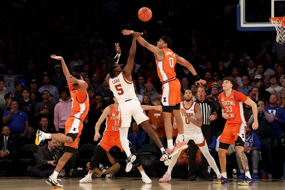 Illinois guard Terrence Shannon Jr. blocks Texas guard Marcus Carr's shot during the second half of the Longhorns' 85-78 overtime loss at Madison Square Garden. It was the first loss of the season for the No. 2-ranked Longhorns.