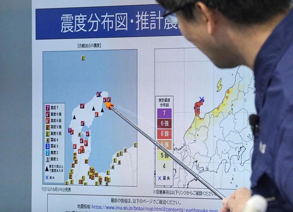 A staff member of Japan Meterological Agency speaks at a press conference in Tokyo Monday, Jan. 1, 2024, following an earthquake. Japan issued tsunami alerts and told people to evacuate seaside areas after a series of strong quakes on its western coastline Monday. (Kyodo News via AP)