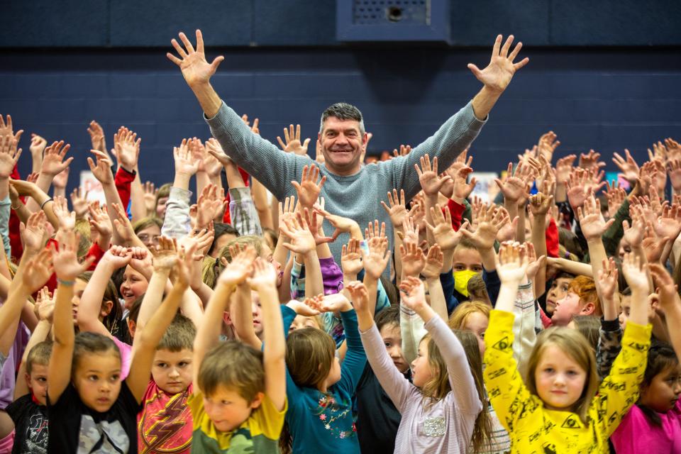 Welsh actor Spencer Wilding, a 6-foot-7-inch kickboxer who played Darth Vader in "Rogue One," poses with hundreds of West Indianola Elementary School students at an assembly Monday afternoon in the school gym.