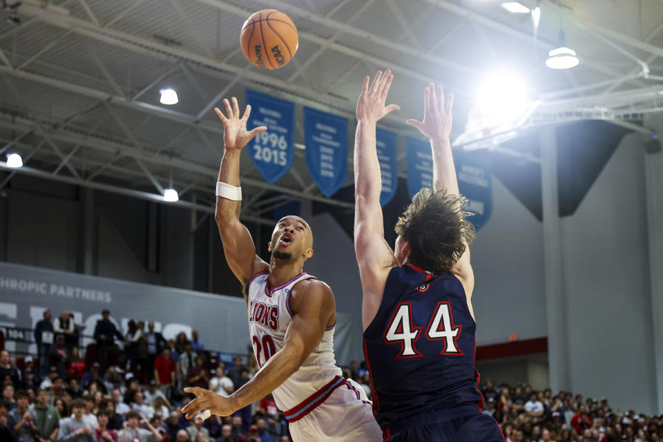 Loyola Marymount guard Cam Shelton, left, shoots against Saint Mary's guard Alex Ducas during the second half of an NCAA college basketball game Thursday, Feb. 9, 2023, in Los Angeles. Loyola Marymount won 78-74. (AP Photo/Ringo H.W. Chiu)