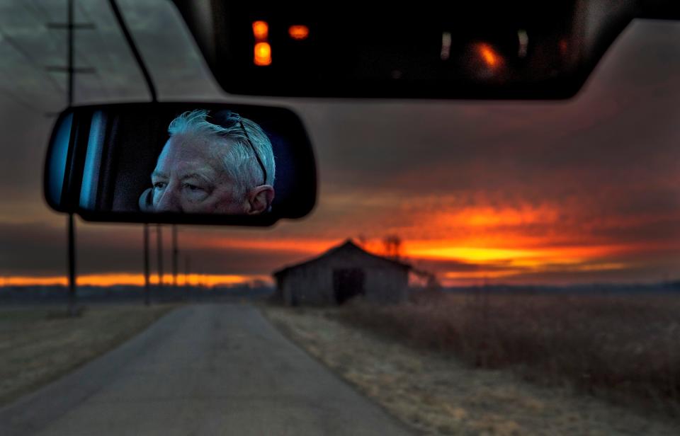 The sun rises over a barn on the side of the road as driver Mark Fawley drives the bus for the Chillicothe Transit System on his way to pick up passengers along his morning route on Dec. 20, 2022 in Chillicothe, Ohio. The Chillicothe Transit System provides free transportation for local passengers in need of transportation around the Chillicothe area.