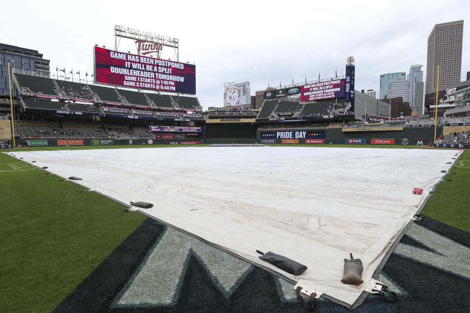 A message announcing the postponement of the baseball game between the Oakland Athletics and the Minnesota Twins is displayed on the scoreboard at Target Field, Saturday, June 15, 2024, in Minneapolis. (AP Photo/Matt Krohn)