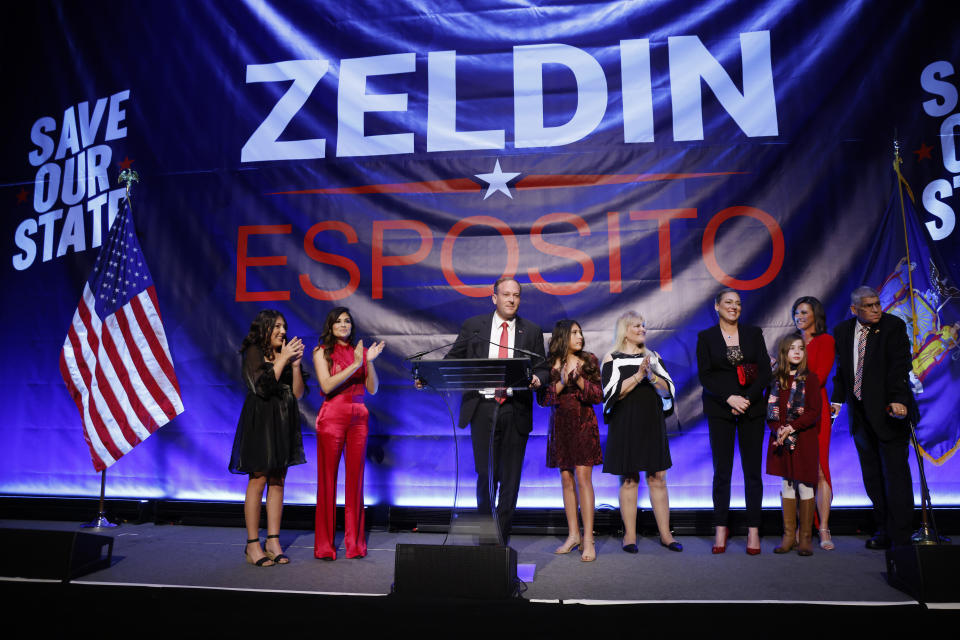Republican gubernatorial candidate Lee Zeldin is joined by family and his running mate, Alison Esposito, third right, as he addresses supporters at his election night party, just after midnight on Wednesday, Nov. 9, 2022, in New York. (AP Photo/Jason DeCrow)