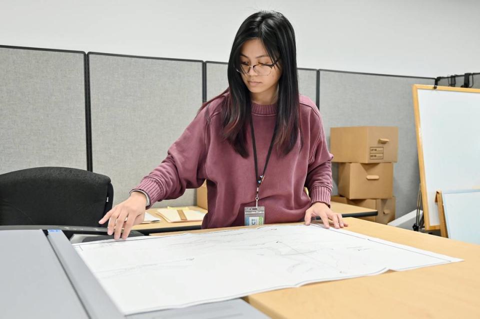 Student assistant Jessica Rilloraza scans a water rights map on a wide-format scanner at the State Water Resources Control Board offices in Sacramento in December.