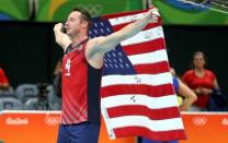 2016 Rio Olympics - Volleyball - Final - Men's Bronze Medal Match USA v Russia - Maracanazinho - Rio de Janeiro, Brazil - 21/08/2016. Team captain David Lee (USA) of USA celebrates with his country's flag after winning the match. REUTERS/Dominic Ebenbichler