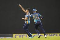 Sri Lanka's Maheesh Theekshana, left, celebrates the wicket of Australia's Josh Inglis during the fifth one-day international cricket match between Australia and Sri Lanka in Colombo, Sri Lanka, Friday, June 24, 2022. (AP Photo/Eranga Jayawardena)