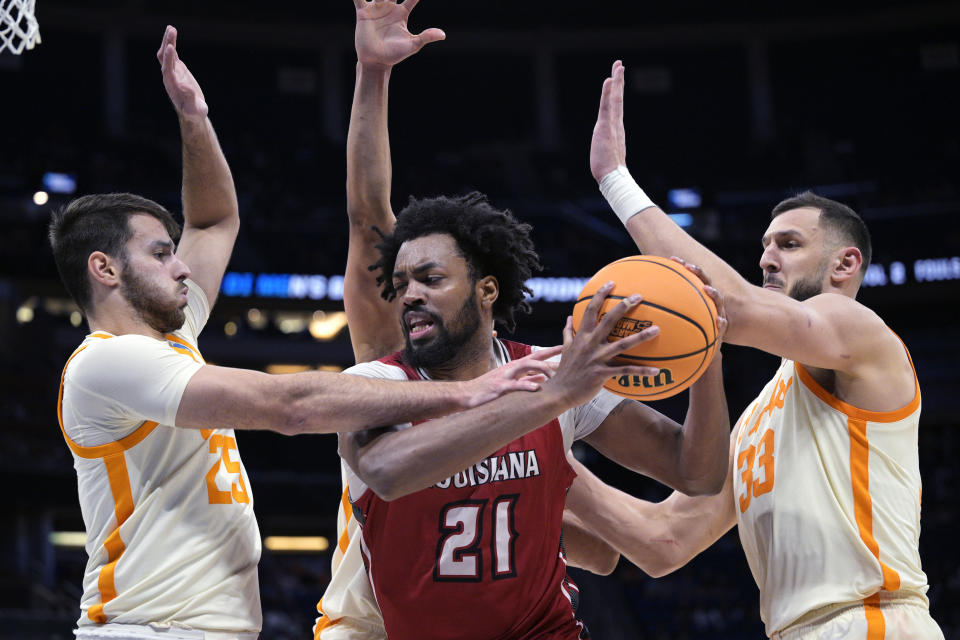 Tennessee guard Santiago Vescovi (25) and forward Uros Plavsic (33) defend against Louisiana forward Jordan Brown (21) during the second half of a first-round college basketball game in the men's NCAA Tournament, Thursday, March 16, 2023, in Orlando, Fla. (AP Photo/Phelan M. Ebenhack)