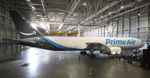 A large plane in a hangar with "Prime Air" emblazoned on the side.