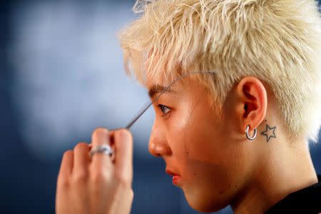 FILE PHOTO: A member of China's all-girl "boyband" FFC-Acrush prepares for the band's maiden press conference in Beijing, China April 28, 2017. REUTERS/Damir Sagolj/File Photo