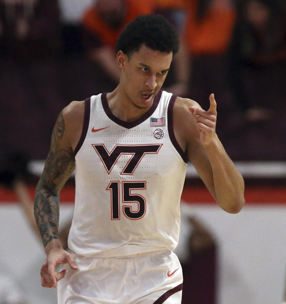 Virginia Tech's Lynn Kidd (15) points teammate MJ Collins after getting an assist for a score in the first half of an NCAA college basketball game against Georgia Tech, Saturday, Jan. 27, 2024, in Blacksburg, Va. (Matt Gentry/The Roanoke Times via AP)