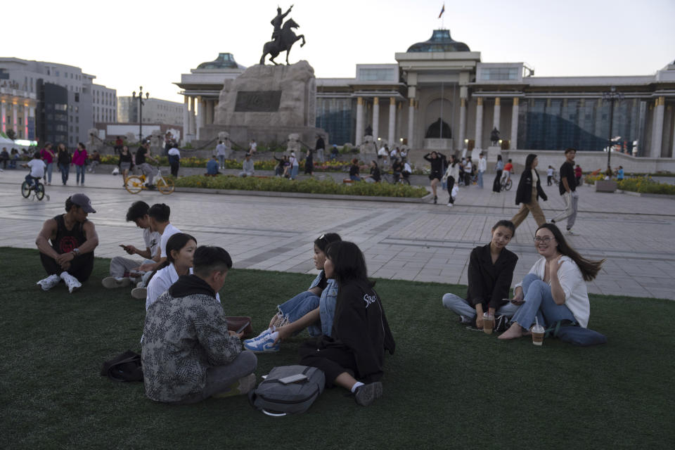 A Mongolian youths rest on a lawn near Sukhbaatar Square in Ulaanbaatar, Mongolia on Tuesday, Aug. 29, 2023. When Pope Francis travels to Mongolia this week, he will in some ways be completing a mission begun by the 13th century Pope Innocent IV, who dispatched emissaries east to ascertain the intentions of the rapidly expanding Mongol Empire and beseech its leaders to halt the bloodshed and convert. (AP Photo/Ng Han Guan)