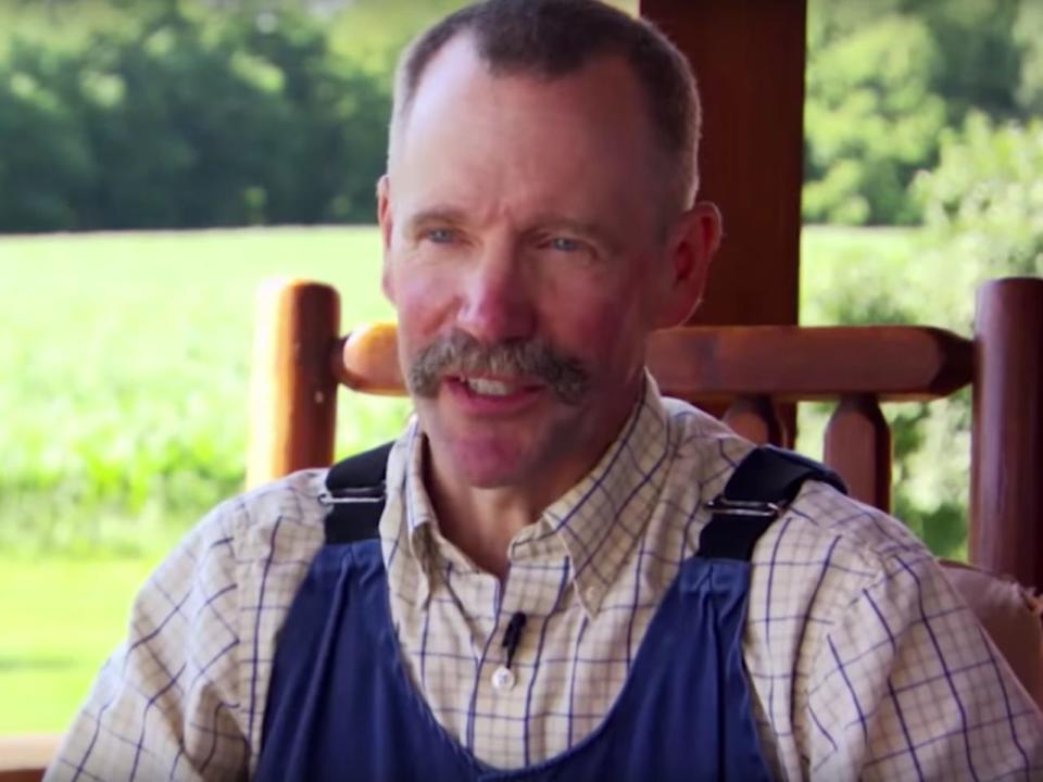 Peter Ostrum in an interview for OWN. He wears a plaid shirt and overalls.