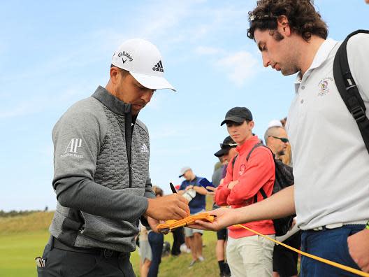 Xander Schauffele signs autographs during a practice round in Portrush (Getty)
