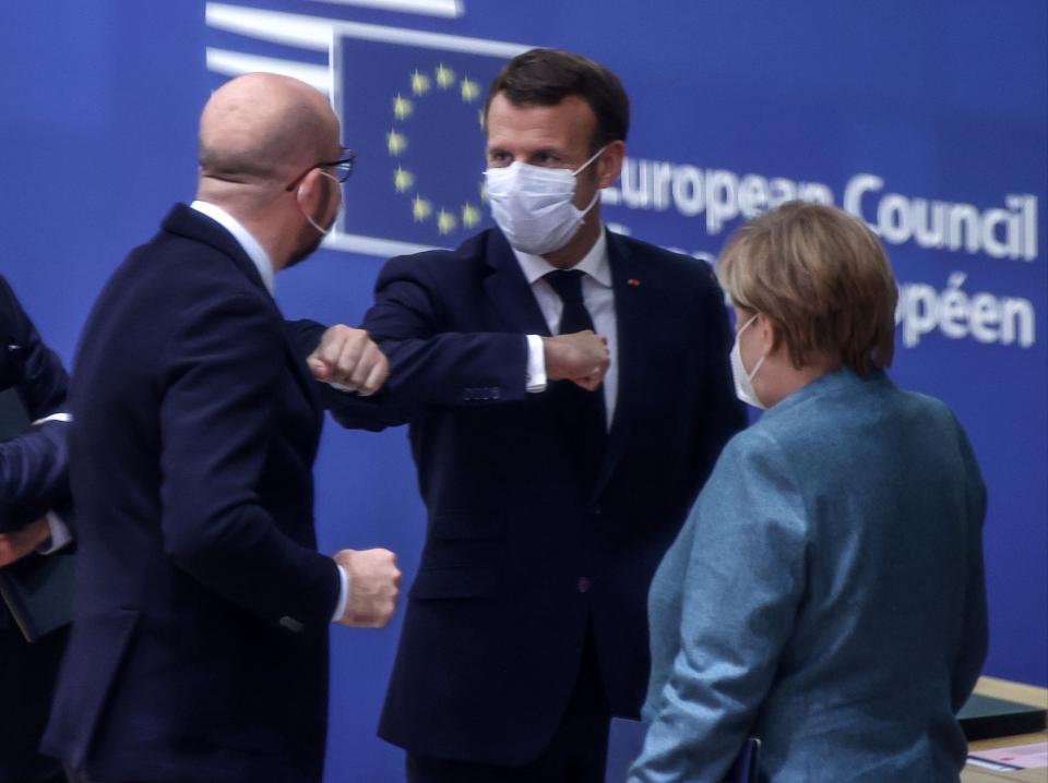<p>Emmanuel Macron (centre) with EU Council president Charles Michel (left) and German chancellor Angela Merkel (right)</p>Pool/AFP via Getty Images