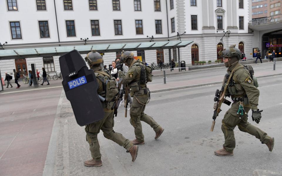 Armed police officers outside Stockholm's central station - Credit: TT News Agency /Reuters