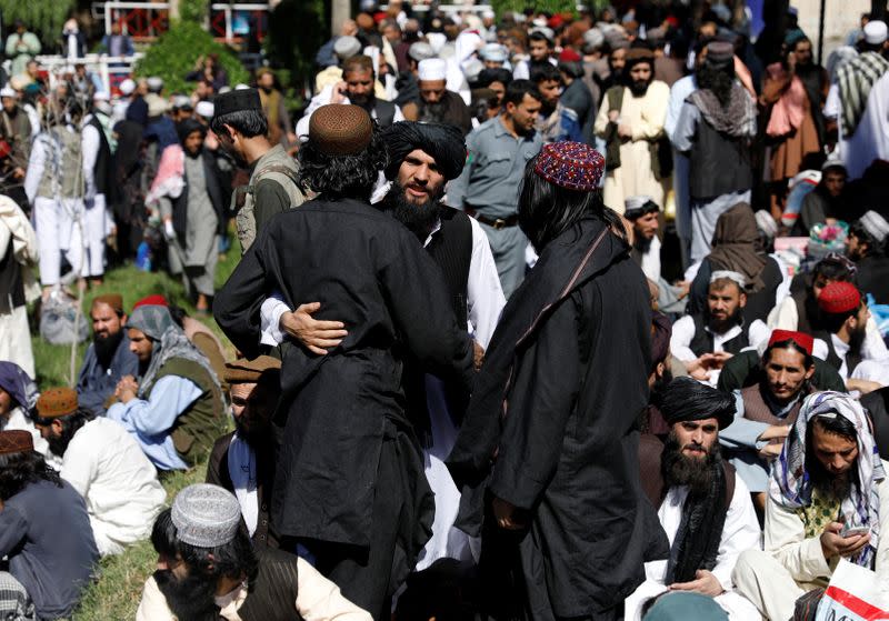 Newly freed Taliban prisoners greet each other at Pul-i-Charkhi prison, in Kabul, Afghanistan