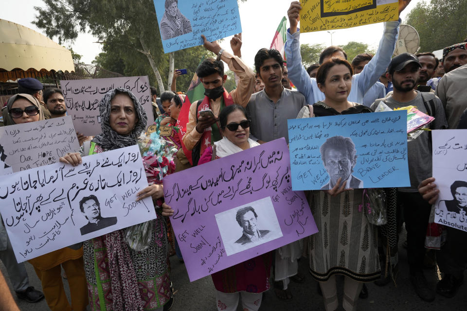 Supporters of former Pakistani Prime Minister Imran Khan's party, Pakistan Tehreek-e-Insaf hold a demonstration to condemn a shooting incident on their leader's convoy, in Lahore, Pakistan, Friday, Nov. 4, 2022. Khan who narrowly escaped an assassination attempt on his life the previous day when a gunman fired multiple shots and wounded him in the leg during a protest rally is listed in stable condition after undergoing surgery at a hospital, a senior leader from his party said Friday. (AP Photo/K.M. Chaudhry)