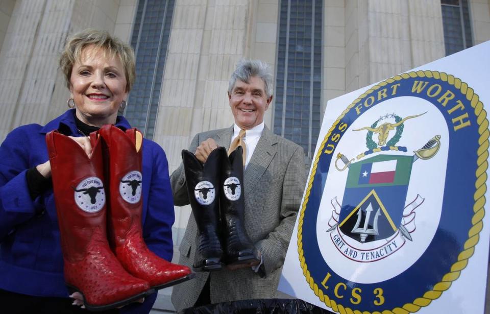 U.S. Rep. Kay Granger and future Congressman Roger Williams hold commemorative boots with the logo of the USS Fort Worth in 2010. (Star-Telegram file photo)