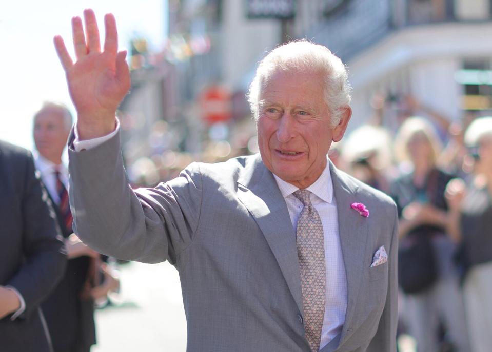 Prince Charles, Prince of Wales waves during a visit to Hay Castle