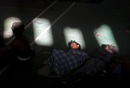 Migrants believed to be Rohingya sleep inside a shelter in Lhoksukon, Indonesia's Aceh Province May 11, 2015. REUTERS/Roni Bintang