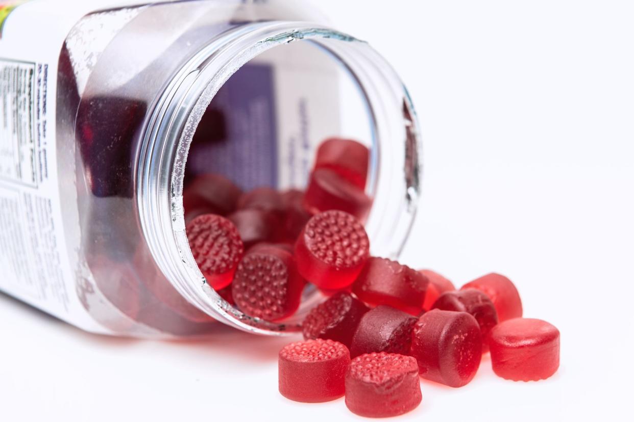 Organic Vegan Gummy vitamins for children coming out of the plastic jar