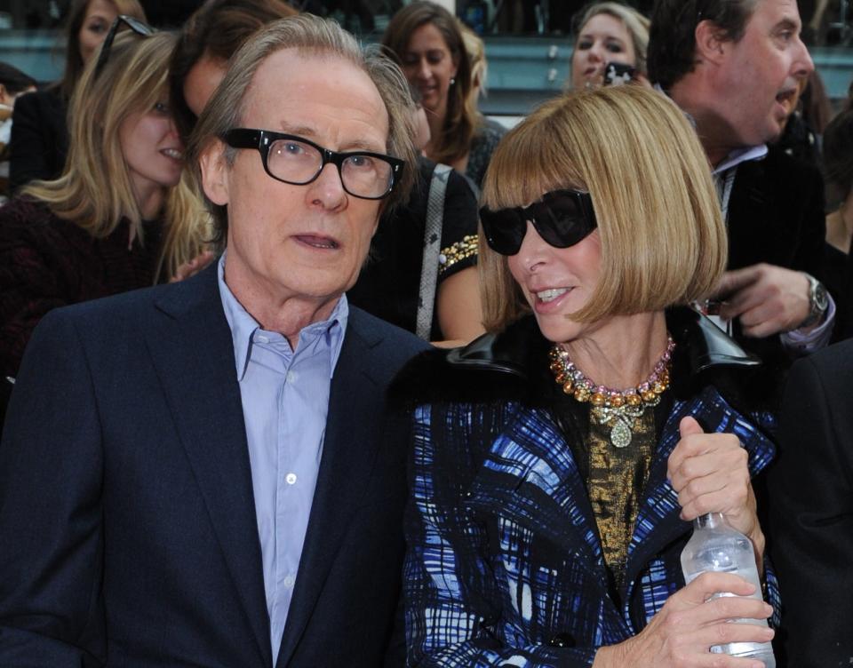 Anna and Bill sit side-by-side at a fashion show