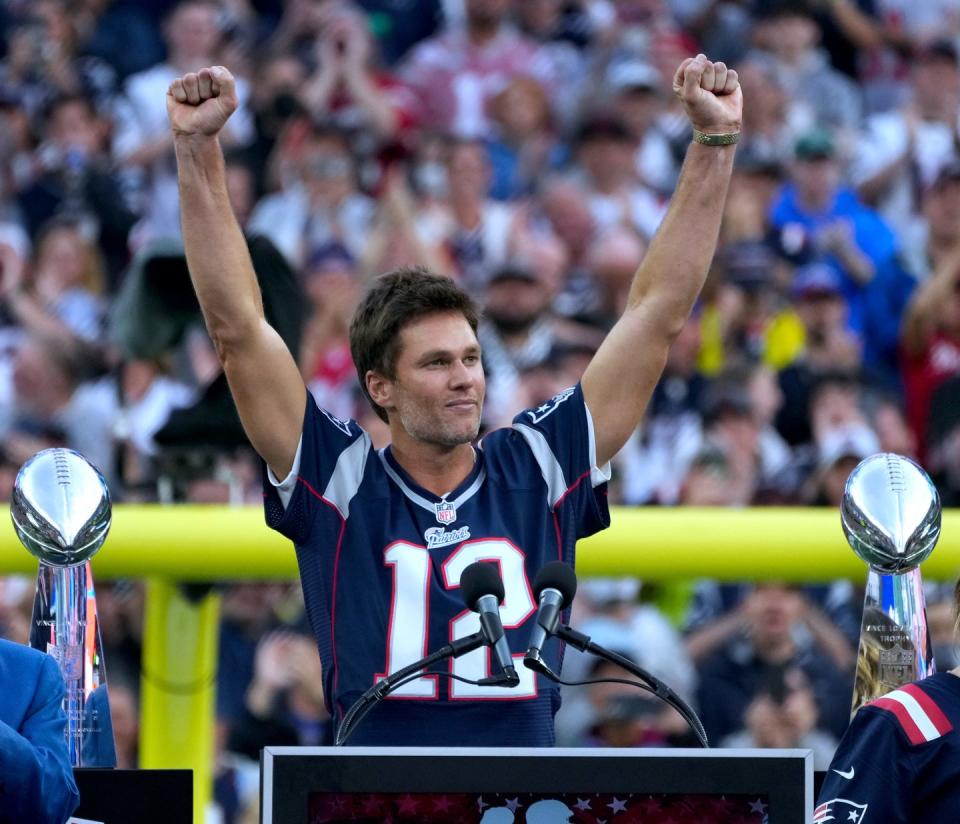 Tom Brady acknowledges his fans during a halftime celebration and the announcement of his induction in the the Patriots Hall of Fame.