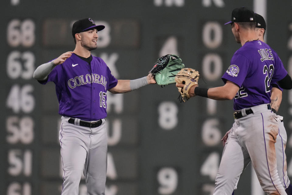 Colorado Rockies left fielder Randal Grichuk, left, celebrates with teammates after defeating the Boston Red Sox 7-6 in a baseball game at Fenway Park, Tuesday, June 13, 2023, in Boston. (AP Photo/Charles Krupa)