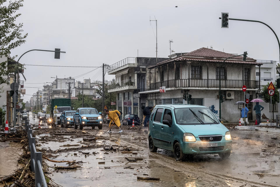 A man clean the debris from floodwaters in the town of Volos, central Greece, Tuesday, Sept. 5, 2023. Police ordered vehicles off the streets of three regions in Greece Tuesday as a severe storm hammered the center of the country and some of its islands, turning streets into flooded torrents and sweeping cars into the sea. (Anastasia Karekla/Eurokinissi via AP)