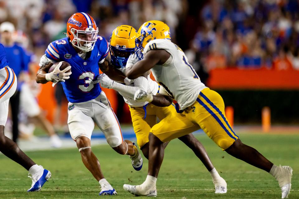 Sep 9, 2023; Gainesville, Florida, USA; Florida Gators wide receiver Eugene Wilson III (3) evades McNeese State Cowboys defensive back Johnquai Lewis (7) and McNeese State Cowboys defensive back Jaylen Jackson (10) during the first half at Ben Hill Griffin Stadium. Mandatory Credit: Matt Pendleton-USA TODAY Sports